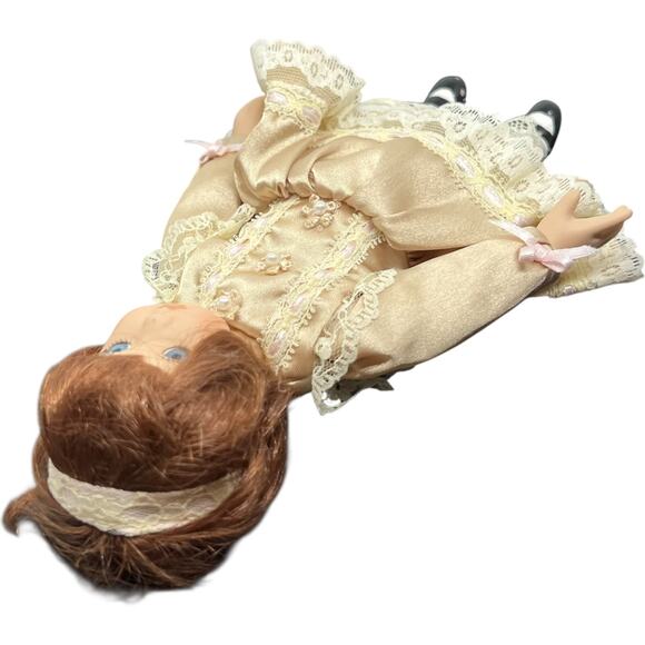 Porcelain Girl Doll in Champagne Satin Dress with Auburn Hair - Picture 9 of 11